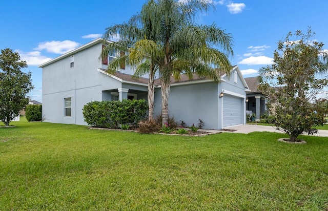 1821 Hawks View Dr, Ruskin, FL 33570 - view of front of property featuring an attached garage, stucco siding, and a front lawn