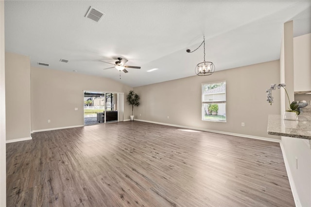 5131 Gato Del Sol Cir, Wesley Chapel, FL 33544 - unfurnished living room featuring plenty of natural light, a ceiling fan, wood finished floors, and vaulted ceiling