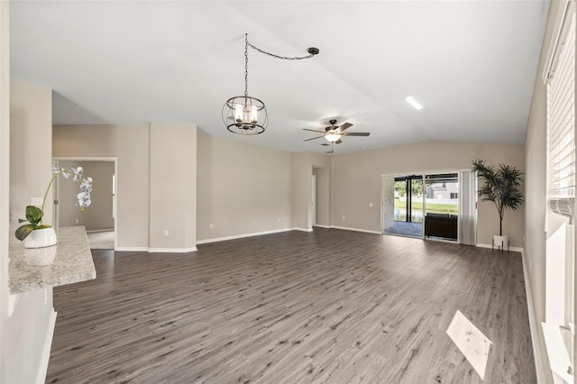 5131 Gato Del Sol Cir, Wesley Chapel, FL 33544 - unfurnished living room with wood finished floors, a ceiling fan, a chandelier, and lofted ceiling