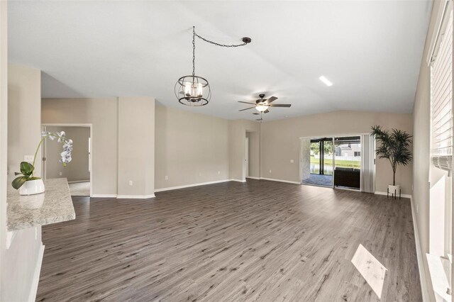 5131 Gato Del Sol Cir, Wesley Chapel, FL 33544 - unfurnished living room with wood finished floors, a ceiling fan, a chandelier, and lofted ceiling