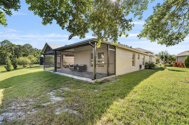 5131 Gato Del Sol Cir, Wesley Chapel, FL 33544 - rear view of house featuring stucco siding, a lawn, a sunroom, and a patio