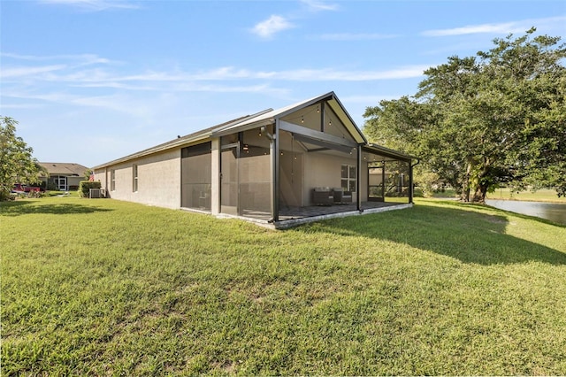 5131 Gato Del Sol Cir, Wesley Chapel, FL 33544 - rear view of house with a lawn and a sunroom