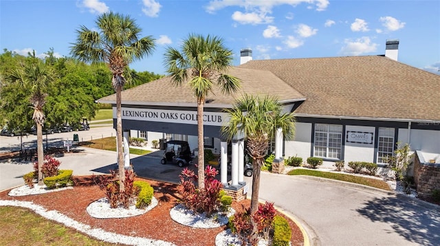 5131 Gato Del Sol Cir, Wesley Chapel, FL 33544 - view of building exterior with asphalt driveway and a carport
