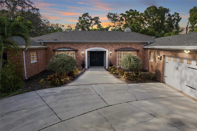 302 Eastleigh Dr, Belleair, FL 33756 - ranch-style house with brick siding, concrete driveway, a chimney, and a shingled roof