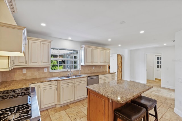 302 Eastleigh Dr, Belleair, FL 33756 - kitchen featuring cream cabinetry, stone tile flooring, gas range, decorative backsplash, and a kitchen island