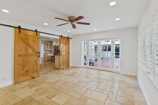 302 Eastleigh Dr, Belleair, FL 33756 - spare room with stone tile floors, a barn door, recessed lighting, ceiling fan, and french doors