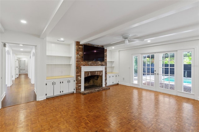 302 Eastleigh Dr, Belleair, FL 33756 - unfurnished living room with beam ceiling, a ceiling fan, a fireplace, french doors, and recessed lighting