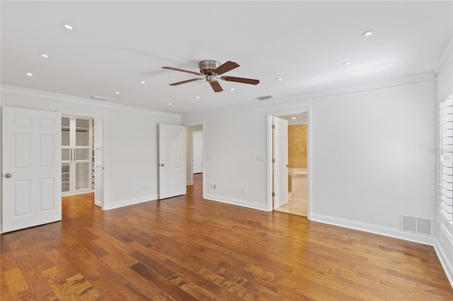 302 Eastleigh Dr, Belleair, FL 33756 - unfurnished bedroom featuring crown molding, recessed lighting, wood finished floors, a spacious closet, and ensuite bath