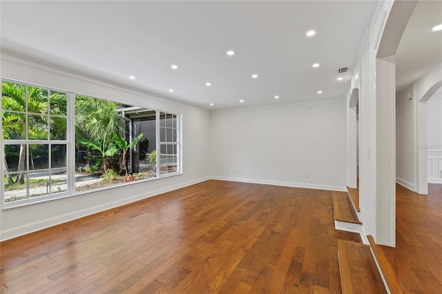 302 Eastleigh Dr, Belleair, FL 33756 - unfurnished room with arched walkways, plenty of natural light, hardwood / wood-style flooring, recessed lighting, and crown molding