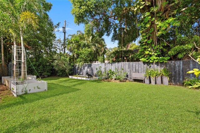 302 Eastleigh Dr, Belleair, FL 33756 - fenced backyard with a vegetable garden
