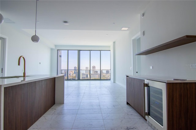 777 3rd Ave N Unit 1704, Saint Petersburg, FL 33701 - kitchen with modern cabinets, beverage cooler, light countertops, light marble finish flooring, and open shelves