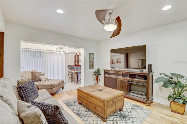2078 Sunset Point Rd Unit 83, Clearwater, FL 33765 - living area featuring light wood-style flooring, ceiling fan, a chandelier, and recessed lighting