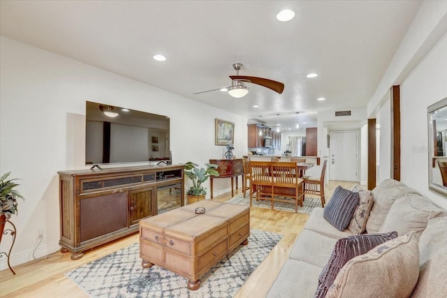 2078 Sunset Point Rd Unit 83, Clearwater, FL 33765 - living room featuring light wood finished floors, ceiling fan, and recessed lighting