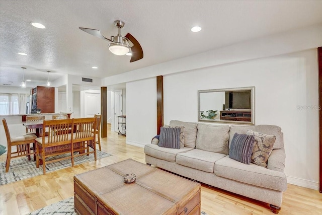 2078 Sunset Point Rd Unit 83, Clearwater, FL 33765 - living area featuring light wood-type flooring, ceiling fan, recessed lighting, and a textured ceiling