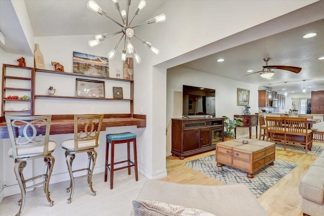 2078 Sunset Point Rd Unit 83, Clearwater, FL 33765 - living room featuring a chandelier, recessed lighting, ceiling fan, and light wood-style flooring