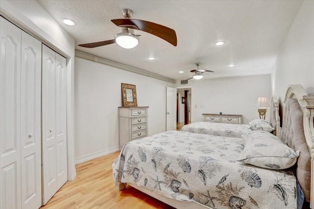 2078 Sunset Point Rd Unit 83, Clearwater, FL 33765 - bedroom featuring a closet, light wood-type flooring, recessed lighting, and ceiling fan