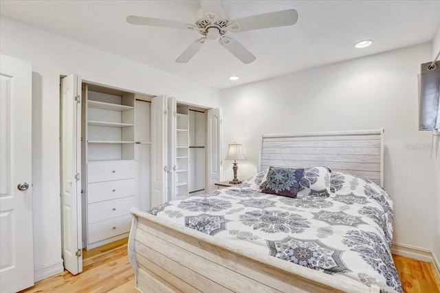 2078 Sunset Point Rd Unit 83, Clearwater, FL 33765 - bedroom with light wood finished floors, ceiling fan, and recessed lighting