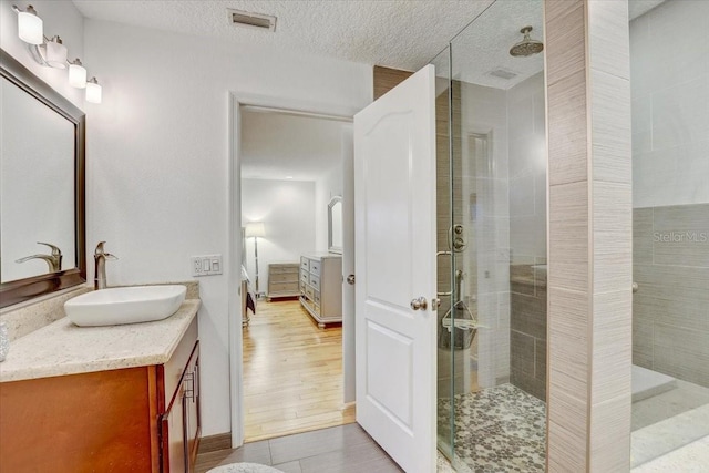 2078 Sunset Point Rd Unit 83, Clearwater, FL 33765 - full bathroom with vanity, a stall shower, and a textured ceiling