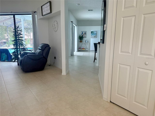 199 N Crystal Meadow Path, Lecanto, FL 34461 - corridor with light tile patterned floors and a textured ceiling