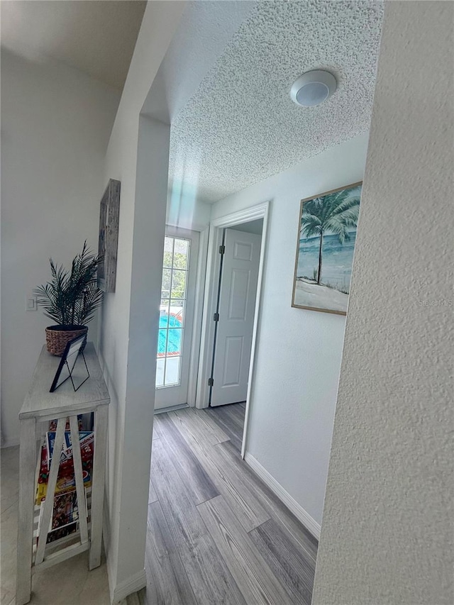199 N Crystal Meadow Path, Lecanto, FL 34461 - hallway with a textured ceiling, wood finished floors, and a textured wall