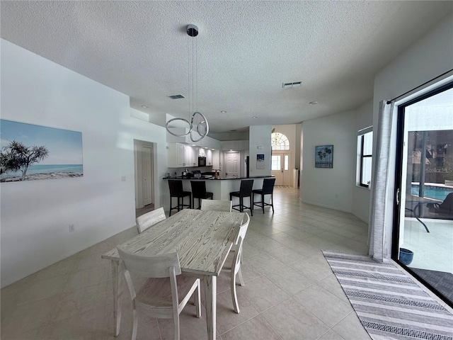 199 N Crystal Meadow Path, Lecanto, FL 34461 - dining area with a textured ceiling, light tile patterned flooring, and a chandelier
