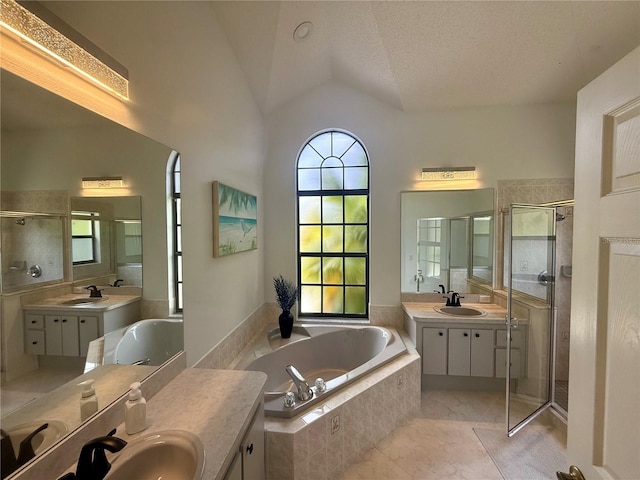 199 N Crystal Meadow Path, Lecanto, FL 34461 - bathroom with healthy amount of natural light, two vanities, a stall shower, a bath, and lofted ceiling