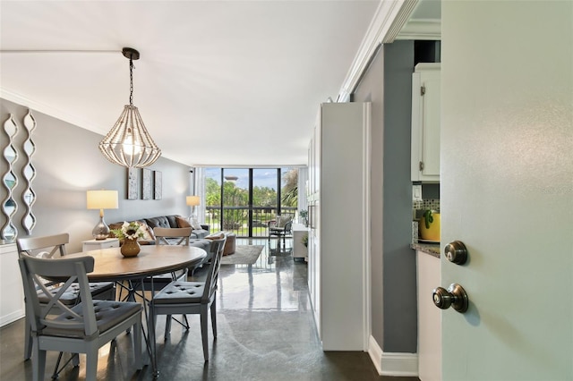 255 Dolphin Pt Unit 207, Clearwater Beach, FL 33767 - dining room with expansive windows, finished concrete flooring, and crown molding