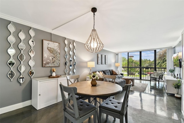 255 Dolphin Pt Unit 207, Clearwater Beach, FL 33767 - dining room featuring ornamental molding, expansive windows, and a chandelier