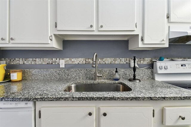 255 Dolphin Pt Unit 207, Clearwater Beach, FL 33767 - kitchen featuring white dishwasher, premium range hood, and white cabinets