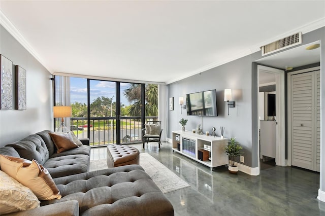 255 Dolphin Pt Unit 207, Clearwater Beach, FL 33767 - living room featuring floor to ceiling windows, crown molding, and concrete flooring