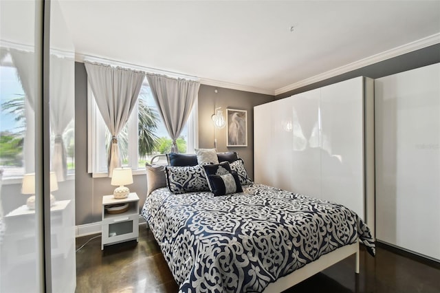 255 Dolphin Pt Unit 207, Clearwater Beach, FL 33767 - bedroom featuring crown molding, wood finished floors, and a closet