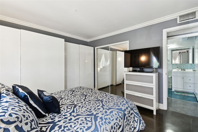 255 Dolphin Pt Unit 207, Clearwater Beach, FL 33767 - bedroom with ornamental molding and ensuite bathroom