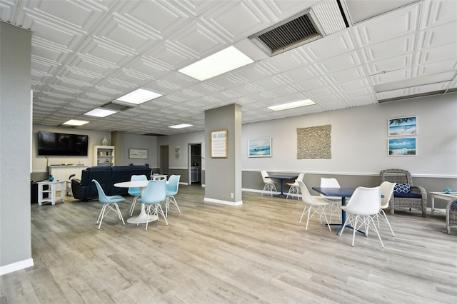 255 Dolphin Pt Unit 207, Clearwater Beach, FL 33767 - dining space featuring wood finished floors and baseboards