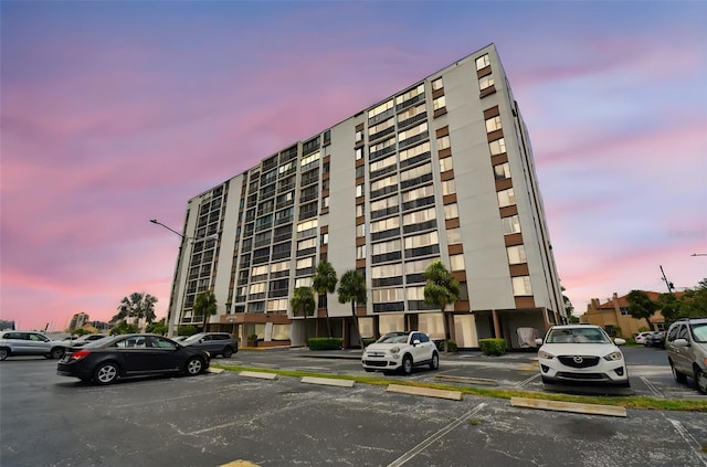 255 Dolphin Pt Unit 207, Clearwater Beach, FL 33767 - property at dusk with uncovered parking