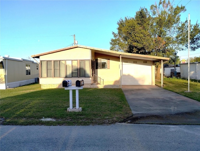 6443 Midland St, Zephyrhills, FL 33542 - view of front of property featuring concrete driveway, a front lawn, an attached garage, and entry steps