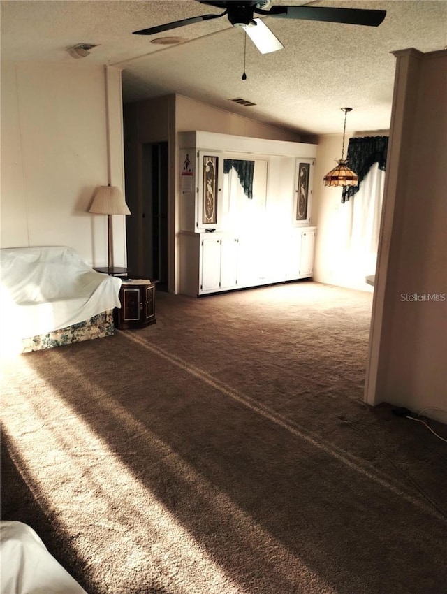 6443 Midland St, Zephyrhills, FL 33542 - unfurnished living room featuring ceiling fan, a textured ceiling, carpet, and lofted ceiling