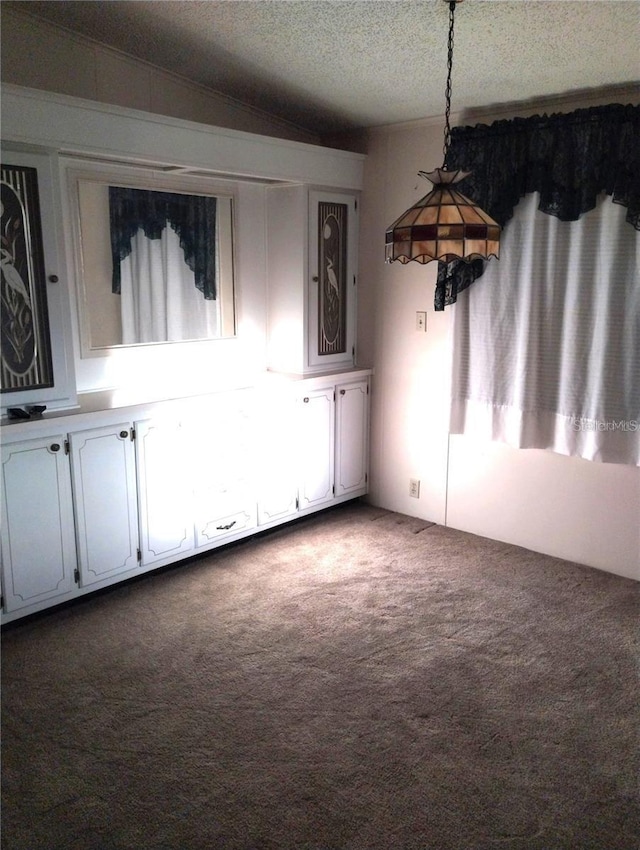 6443 Midland St, Zephyrhills, FL 33542 - unfurnished dining area featuring carpet floors and a textured ceiling