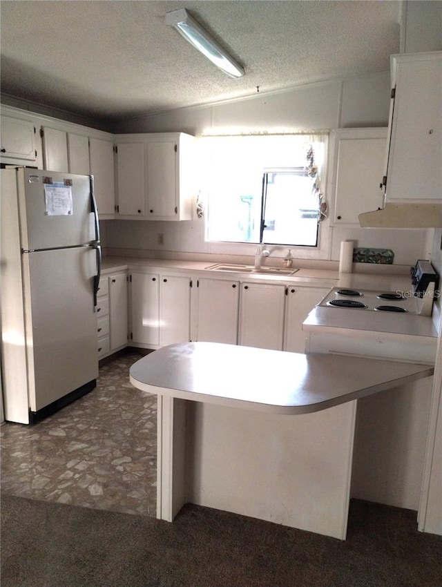 6443 Midland St, Zephyrhills, FL 33542 - kitchen featuring freestanding refrigerator, white cabinetry, a textured ceiling, and light countertops