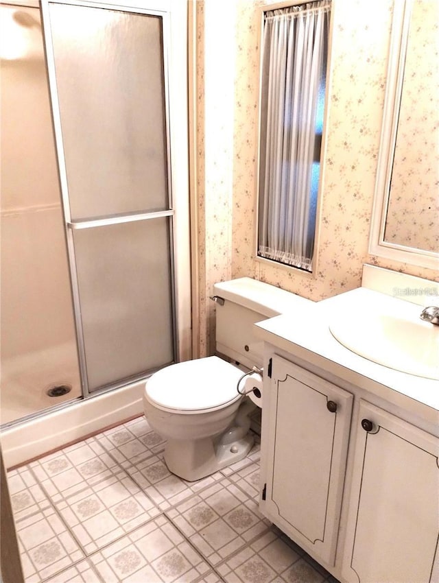 6443 Midland St, Zephyrhills, FL 33542 - full bath featuring wallpapered walls, vanity, a shower stall, and tile patterned floors