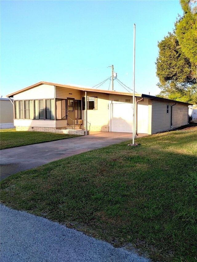 6443 Midland St, Zephyrhills, FL 33542 - view of front facade with driveway and a front lawn