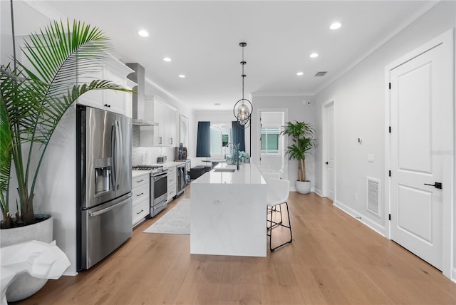 4515 W N A St Unit 6, Tampa, FL 33609 - kitchen featuring appliances with stainless steel finishes, a center island with sink, white cabinetry, recessed lighting, and light countertops