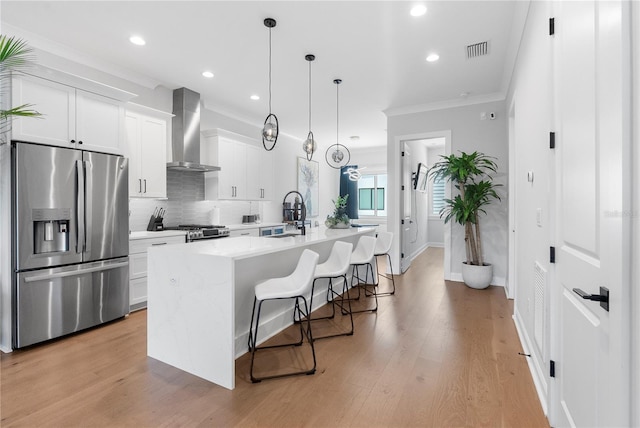 4515 W N A St Unit 6, Tampa, FL 33609 - kitchen with stainless steel appliances, wall chimney exhaust hood, crown molding, a center island with sink, and recessed lighting