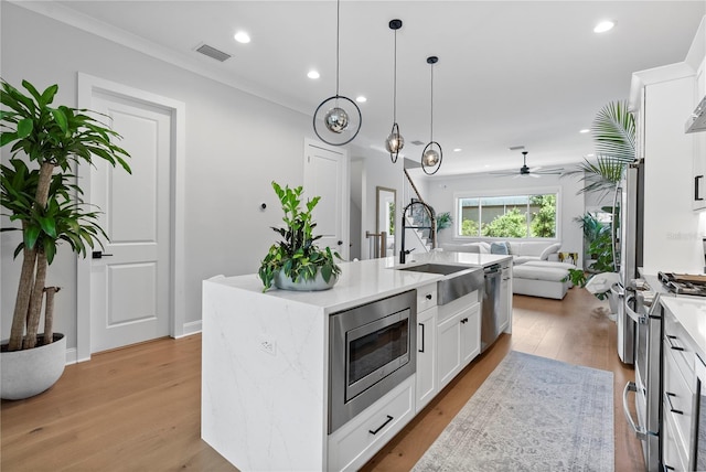 4515 W N A St Unit 6, Tampa, FL 33609 - kitchen featuring stainless steel appliances, open floor plan, white cabinets, light countertops, and recessed lighting
