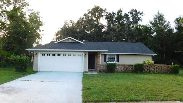 6605 Foxmoor Dr, Zephyrhills, FL 33542 - ranch-style house with driveway, an attached garage, and a front lawn