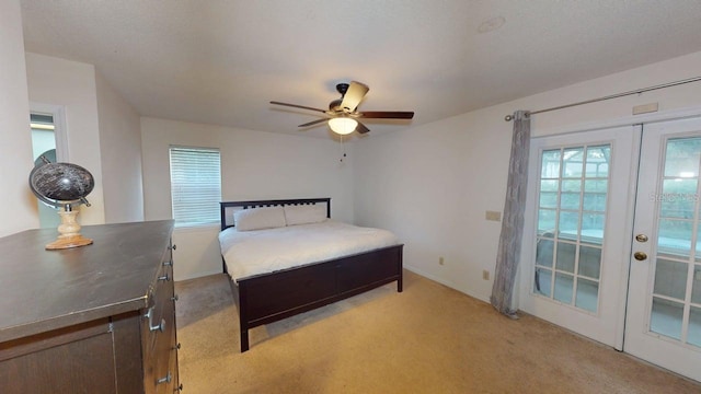 6605 Foxmoor Dr, Zephyrhills, FL 33542 - bedroom with light carpet, french doors, and ceiling fan