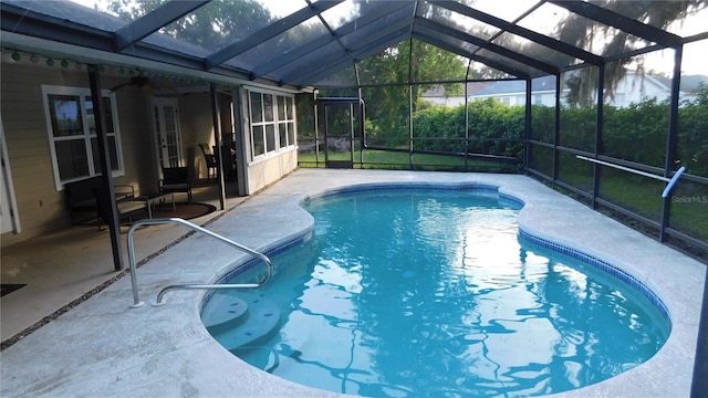 6605 Foxmoor Dr, Zephyrhills, FL 33542 - swimming pool featuring a patio, glass enclosure, and ceiling fan