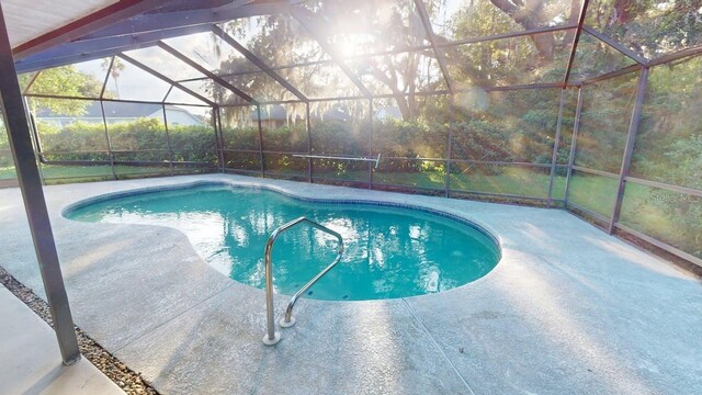 6605 Foxmoor Dr, Zephyrhills, FL 33542 - swimming pool featuring glass enclosure and a patio