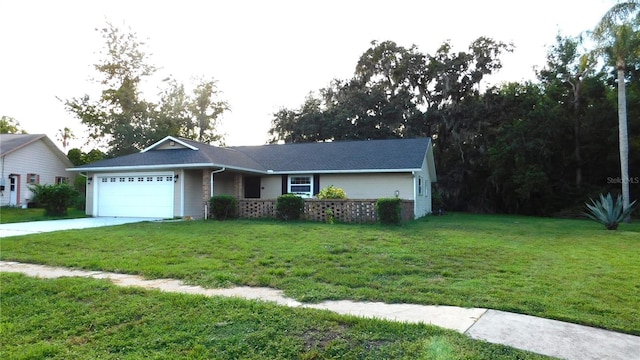 6605 Foxmoor Dr, Zephyrhills, FL 33542 - ranch-style home featuring an attached garage, a front yard, and concrete driveway