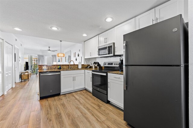 12000 Gulf Blvd Unit 506N, Treasure Island, FL 33706 - kitchen featuring appliances with stainless steel finishes, a peninsula, white cabinets, recessed lighting, and a textured ceiling