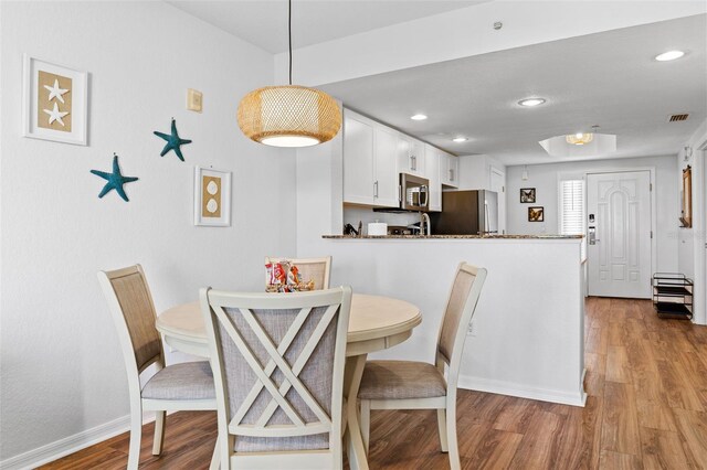 12000 Gulf Blvd Unit 506N, Treasure Island, FL 33706 - dining space featuring wood finished floors and recessed lighting